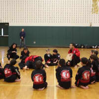 <p>Martial arts students at The Dojo listen to an instructor.</p>