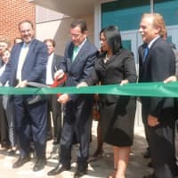 <p>Gov. Dannel P. Malloy cuts the ribbon at the reopened J.M. Wright Technical High School on Wednesday.</p>