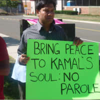 <p>Noor Islam holds a sign outside the Stamford Superior Court as part of a call for justice for Mahomed Kamal, 47, who was stabbed to death early Wednesday. His alleged killer Shota Mekoshvili made his first appearance in court on Friday.</p>