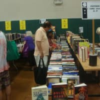 <p>Redding readers fill up bags with books of all genres at the book fair.</p>