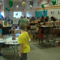 <p>Kids peruse the collection of children&#x27;s books available at the fair.</p>