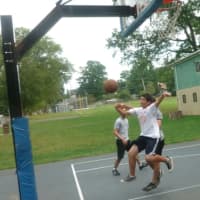 <p>Sebastian Neufuss, 16, goes for the ball during a pickup basketball game with a group of friends on Labor Day in Stamford.</p>