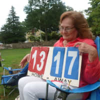 <p>Teresa Correa keeps score for friends playing volleyball at Barrett Park on Labor Day.</p>
