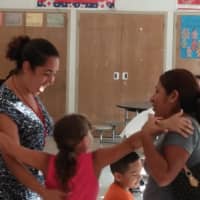 <p>Elmsford&#x27;s Alice Grady and Carl Dixson school Principal Madeline Paneto-Gonzalez, left, greets students and parents on opening day of school on Tuesday.</p>