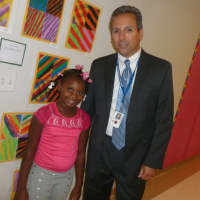 <p>Julia A. Stark first grade student Kameiya St. Juste, stands with her principal Mark Bonasera on the first day of school Tuesday.</p>