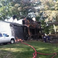 <p>A large home at 25 Bittersweet Lane in North Stamford is in ruins after an overnight fire. </p>