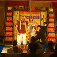 <p>An audience member takes part in one of the circus performances in the Kids&#x27; Cove Big Top Theater.</p>