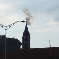 <p>Smoke and flames can be seen coming from the steeple at Little Zion Church of Christ.</p>