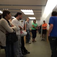 <p>Customers at the Apple Store in The Westchester mall crowd around to watch the live stream of the iPhone 6 launch Tuesday. </p>