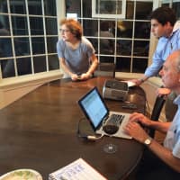 <p>Leon Potok (center) tracks results in the Democratic Primary for the Village of Mamaroneck Tuesday night. </p>