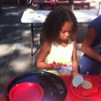 <p>A young girl creates a cookie masterpiece. </p>