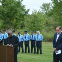 <p>Rev. Joseph Domfeh Boateng speaks at the 9/11 ceremony. To his right is Pound Ridge Supervisor Dick Lyman. Firefighters stand in the background.</p>