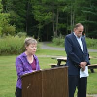 <p>Pastor Lori Miller speaks at Pound Ridge&#x27;s 9/11 memorial service. Pound Ridge Supervisor Dick Lyman is pictured to the right.</p>