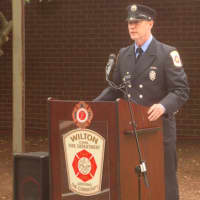 <p>Firefighter James Blanchfield leads the Wilton memorial ceremony at the fire station.</p>