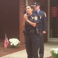 <p>Wilton Police Officer Anna Tornello sings during the Sept. 11 tribute ceremony.</p>