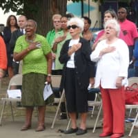<p>Attendees at a 9/11 Memorial event at Jackie Robinson Park in Stamford sing the &quot;Star Spangled Banner.&quot;</p>