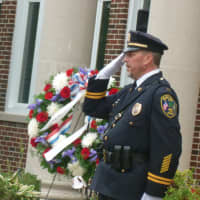 <p>New Canaan Police Capt. Vincent DiMaio, salutes during the New Canaan 9/11 ceremony. </p>