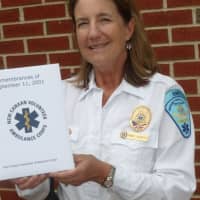 <p>Wendy Humboldt, captain of the New Canaan Volunteer Ambulance Corps, holds a book of 9/11 memories compiled by corps members.</p>