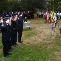 <p>Police salute the wreaths in front of the Girl Scout Rock Memorial. </p>
