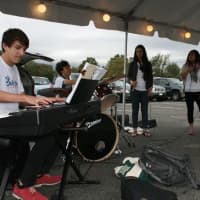 <p>Ryan Fedak, Mikey&#x27;s brother, plays music at the event along with other musicians.</p>