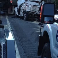 <p>A heavily damaged car on the shoulder of the road of east-bound I-287 Friday.</p>