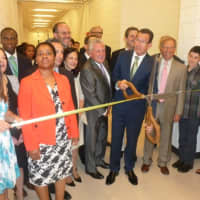 <p>Gov. Dannel P. Malloy prepares to cut the ribbon at the official opening of the Norwalk Early College Academy at Norwalk High School on Friday. NECA allows students to earn a high school diploma and a two-year degree from Norwalk Community College.</p>