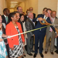 <p>Gov. Dannel P. Malloy cuts the ribbon at the official opening of the Norwalk Early College Academy at Norwalk High School on Friday. NECA allows students to earn a high school diploma and a two-year degree from Norwalk Community College.</p>