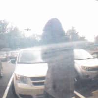 <p>Footage from an ATM camera of the suspect outside the bank.</p>