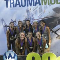 <p>A team of young women gets together for a team photo after the race.</p>