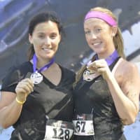 <p>Finishers show their medals after the race.</p>