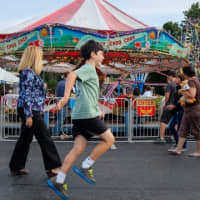 <p>A boy hops around with excitement at the Greek Festival, held at 10 Mill Road. </p>