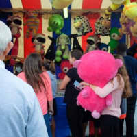 <p>Families line up participate in hopes of claiming a prize during the Greek Festival. </p>