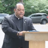 <p>The Rev. Reginald Norman speaks before the attendees at Our Lady of Fatima School&#x27;s 9/11 Memorial Service.</p>