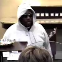 <p>The suspect in the robbery of the Union Savings Bank at 226 Main St. is shown in surveillance photos.</p>