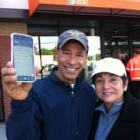 <p>Eddie Senker holds up his wife Shelley&#x27;s new iPhone 6 after they left the AT&amp;T retail store at 2147 Summer St. in Stamford on Friday morning. Shelley Senker got in line at 6 a.m. </p>
