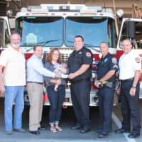 <p>Westport Firefighter Dan Mascolo and his family were presented with a donation from The Umbrella Club on Sept. 12. </p>