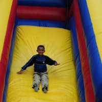 <p>A child goes down a slide ride. </p>