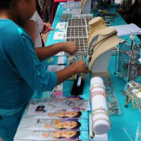 <p>Residents visit vendors who sell jewelry. </p>