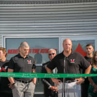<p>Scott Lauder accompanied by Nick Serio, speaks at the Athletes Warehouse grand opening.</p>