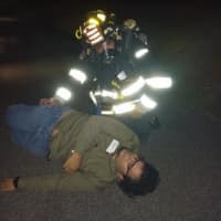 <p>A victim and a firefighter act out a scene. </p>