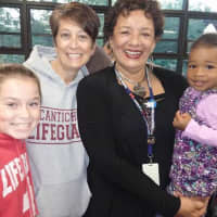 <p>Pocantico Hills School Superintendent Valencia Douglas, right, and her granddaughter, District Clerk and Secretary Gina Downes, left, and her daughter at the PTA Pasta Dinner Friday, Sept. 19.</p>