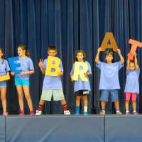 <p>Student volunteers work together to spell out the word of the month  celebrate.</p>