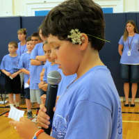 <p>Students read off the names of classmates who celebrate September birthdays.</p>