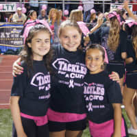 <p>Cheerleaders and football players sold T-shirts and raised more than $14,000 during Tackles for a Cure.</p>