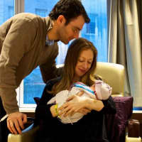 <p>Chelsea Clinton and her husband, Marc Mezvinsky, with their daughter Charlotte.</p>