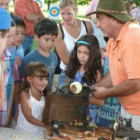 <p>Jared Silbersher demonstrates old apple people technology to an appreciative audience Sunday at the Ambler Farm fall festival.</p>