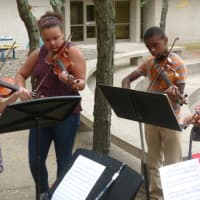 <p>Cloonan Middle School students, from left, Caroline Kavanagh, Precious Thomas, Ben Jean and Christopher Chung play during the official opening Monday of the Family Centers newest clinic that will be located in the middle school.</p>