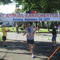 <p>Michael Nobles, winner of the Eastchester 5K Race, crosses the finish line.</p>