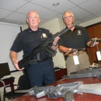 <p>Stamford Police Officer Joseph Steyer, at left, holds a Kalashnikov assault rifle, while Sgt. Tom Wolff holds a pair of handguns.</p>