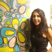 <p>Loren DePalma with her piece &quot;Zeal&quot; which is now on display as part of the &quot;Deja New&quot; exhibit at the Maritime Garage Gallery in Norwalk.</p>